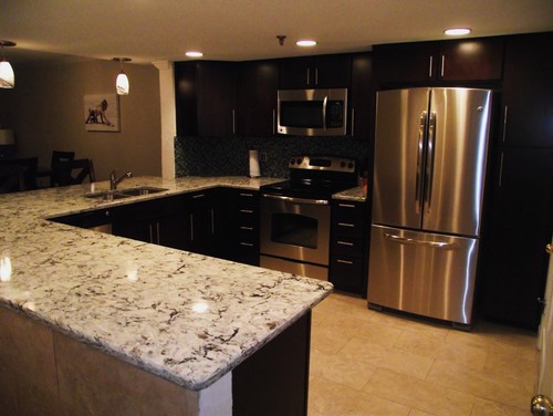 Cambria Praa Sands with Cappuccino Kitchen Cabinets, Travertine Flooring, Dark Color Matchstick Backsplash and Stainless Steel Appliances